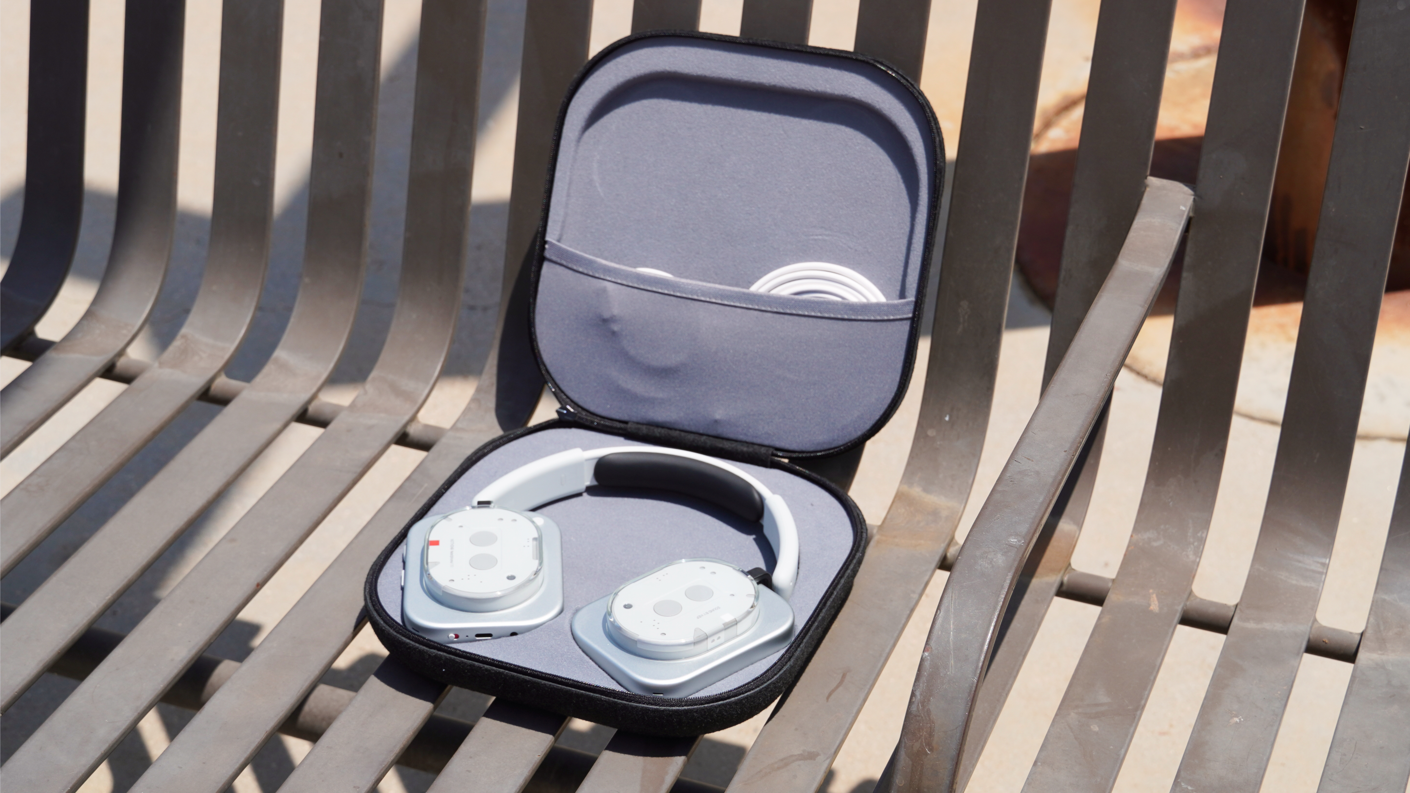 The Nothing Headphone 1 case opened up, revealing the headphones and included cables.