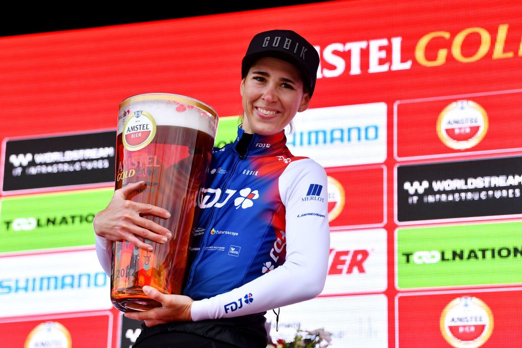 2022 Amstel Gold Race winner Marta Cavalli with the sponsor&#039;s traditional enormous beer