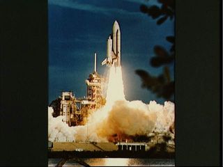 A view of the shuttle Columbia as it soars beyond the launch pad into space on its STS-1 mission on April 12, 1981. This flight marked the beginning of NASA's space shuttle program. 