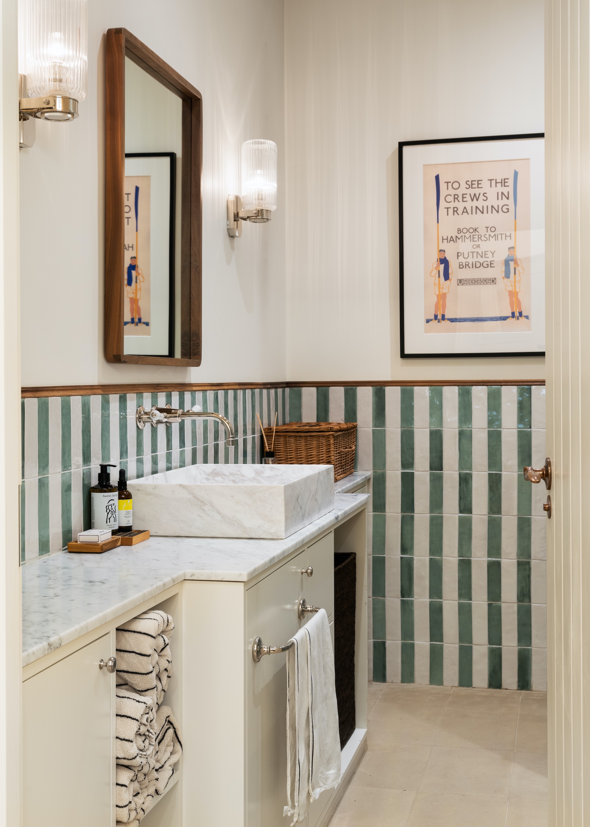 bathroom with striped wall tiles and marble basin
