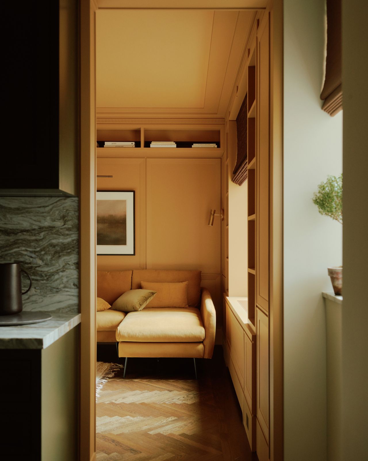 A view into a yellow family room for a green galley kitchen