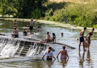 Bathers at Warleigh Weir in Bath, UK