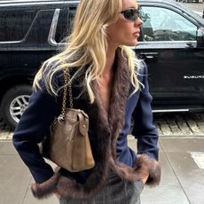 Elsa Hosk wearing a navy-blue jacket by Valentino with fur trim. 