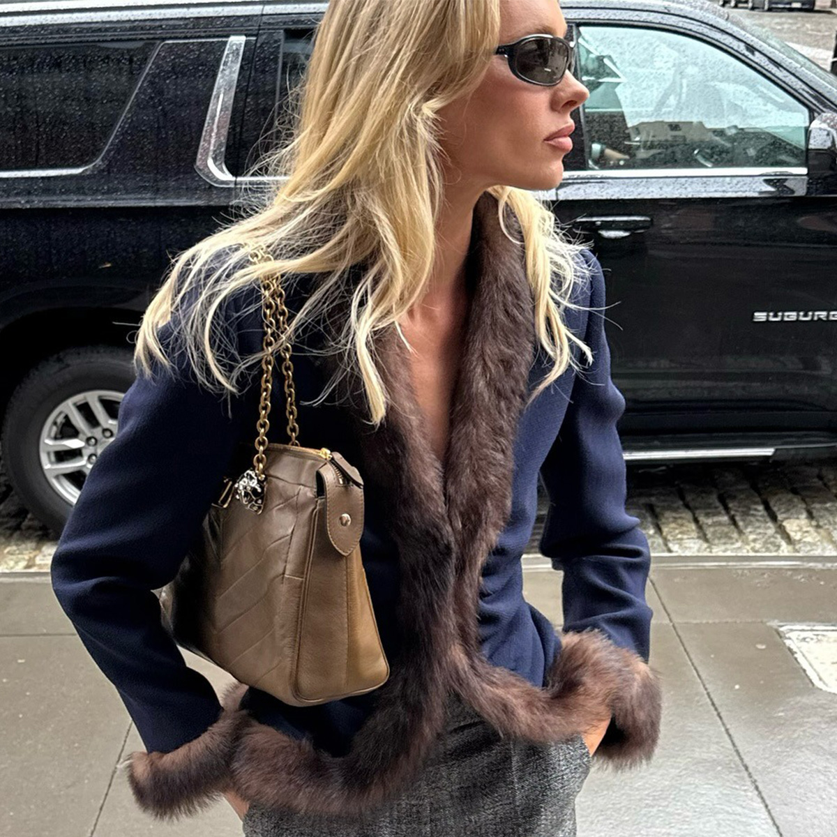 Elsa Hosk wearing a navy-blue jacket by Valentino with fur trim. 