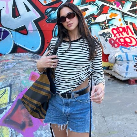 Dua Lips in stripe tee and denim shorts