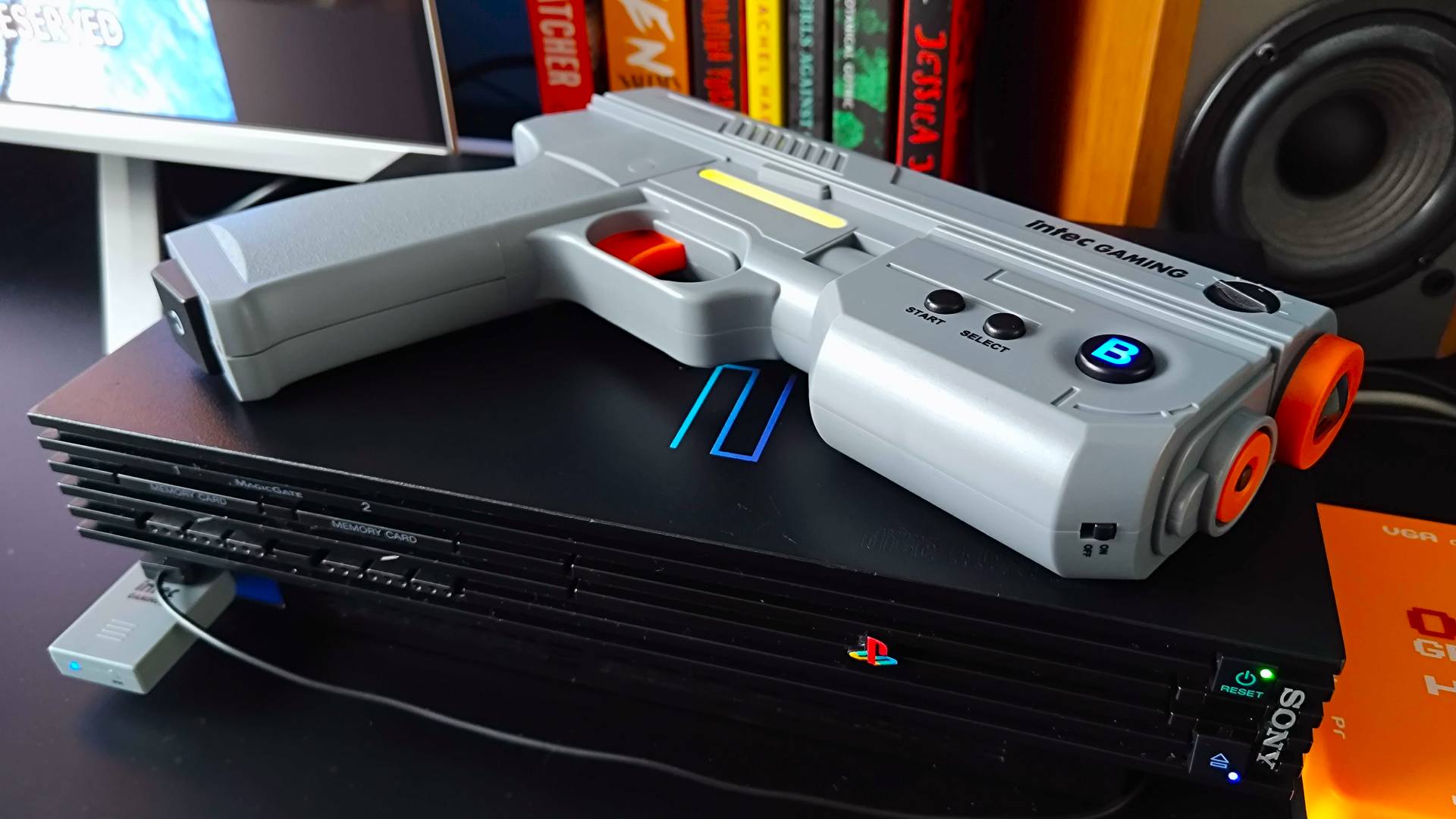 Intec Time Breaker Lightgun sitting on top of PS2.