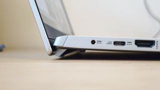 A silver Acer Swift 3 laptop on a light wooden desk