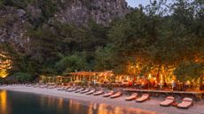 View of beach and restaurant at Yazz Collective hotel, Turkey, at dusk