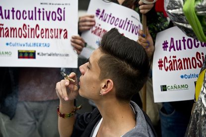 A young person smokes pot at a protest in Mexico.