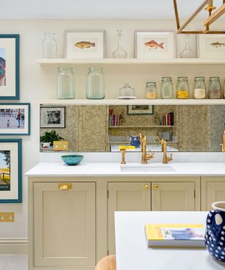 Cream kitchen with beige cabinets and gold faucets