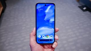 Google Pixel 9a held in the hand.