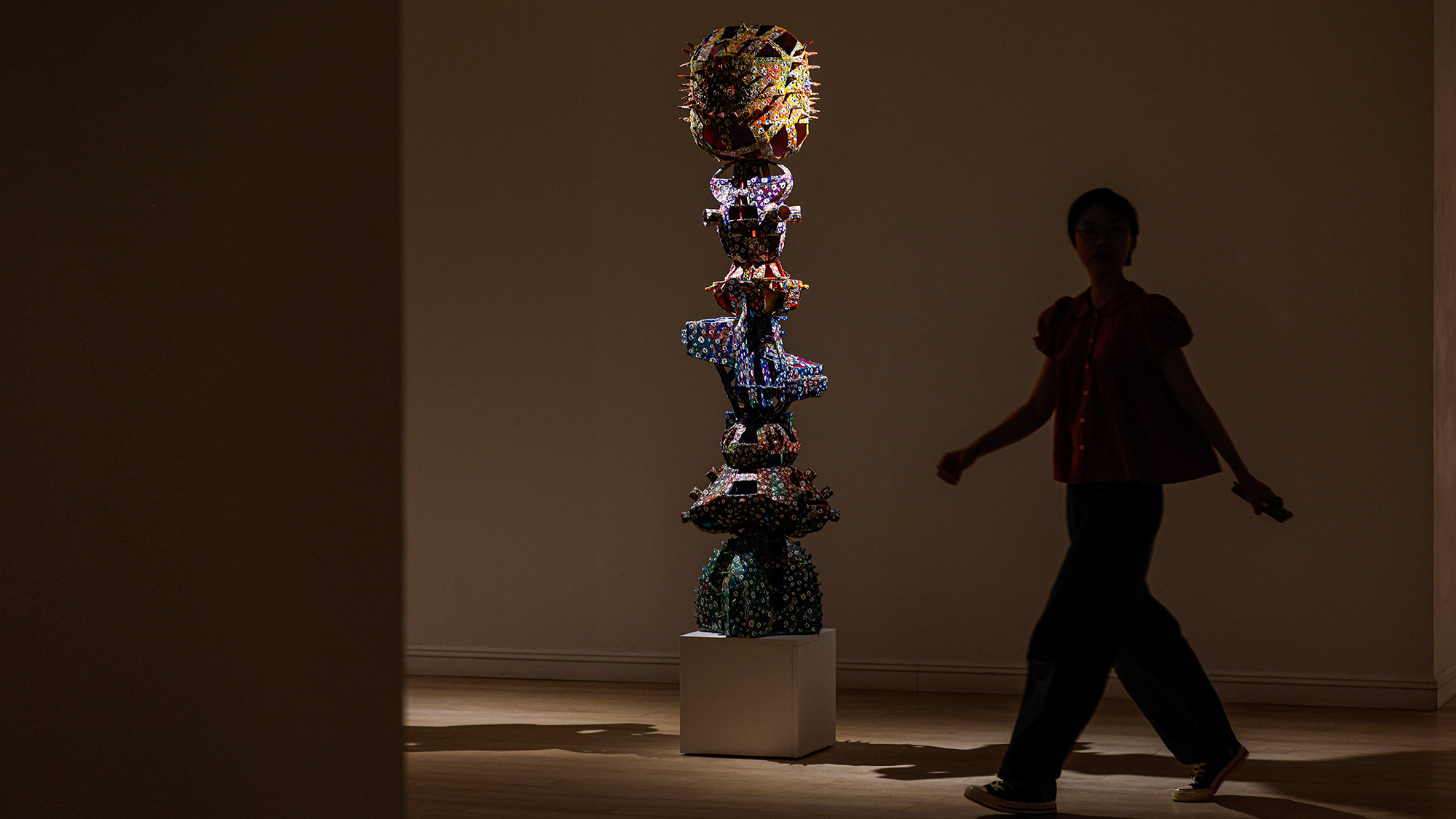 A visitor explores artist Tèo Phạm's 'This World Is Perfectly Stunning, Let Us Make It Truly Blinding' exhibition at Mo Art Space in Hanoi, Vietnam