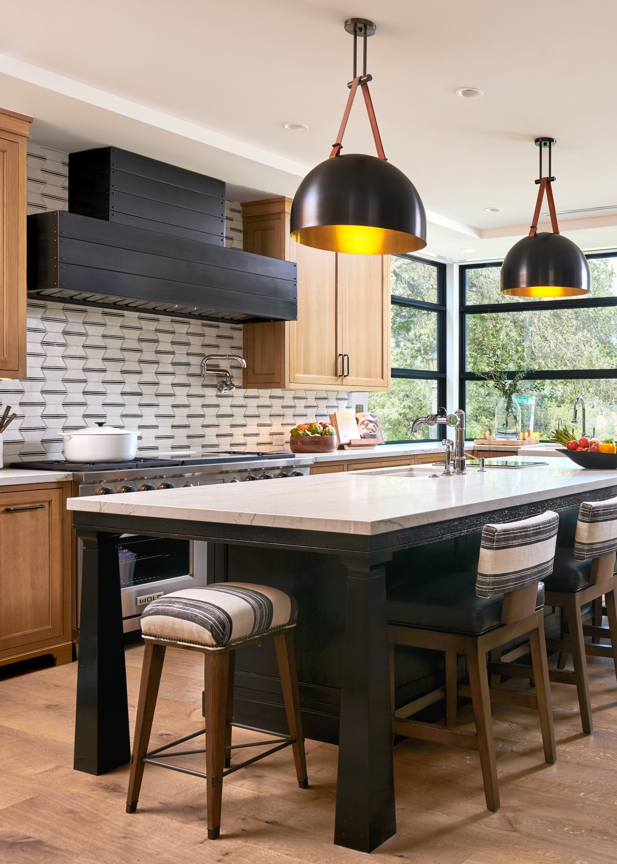 wood kitchen with black island striped stools