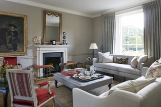 Large grey ottoman, wicker carpet, cream and grey sofas