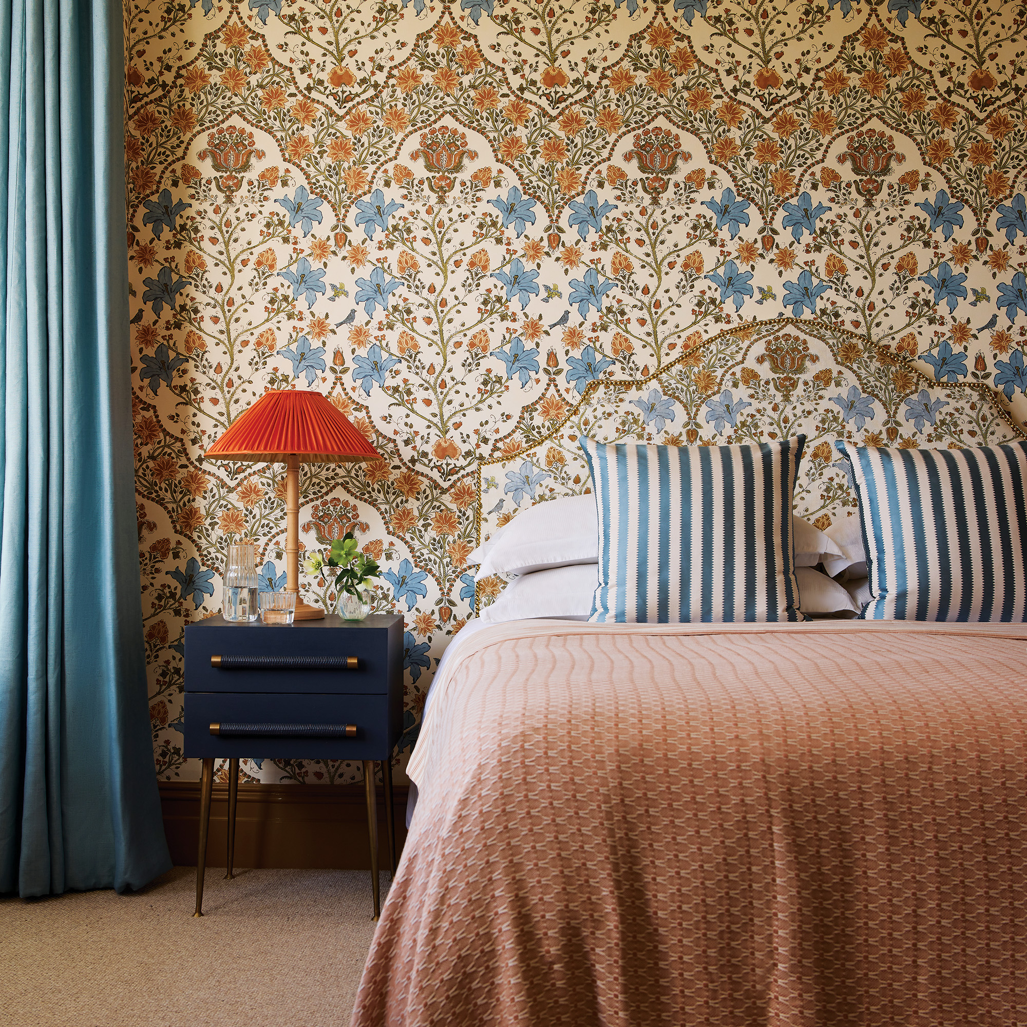 pattern drenching with headboard and wallpaper in the same print with complementary bedlinen and navy bedside table laura stephens