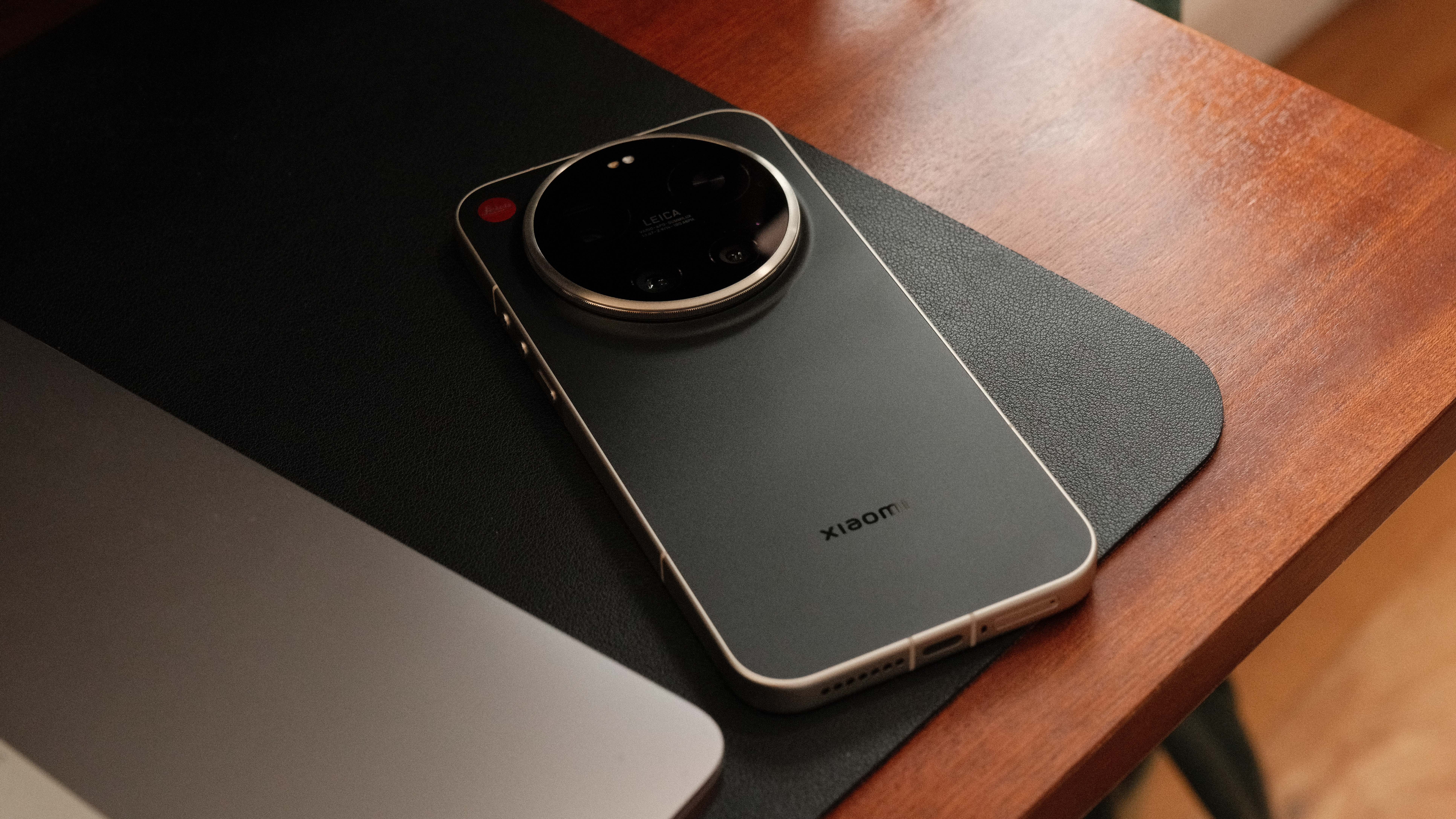 Leica Leitz Phone placed on a desk beside a laptop