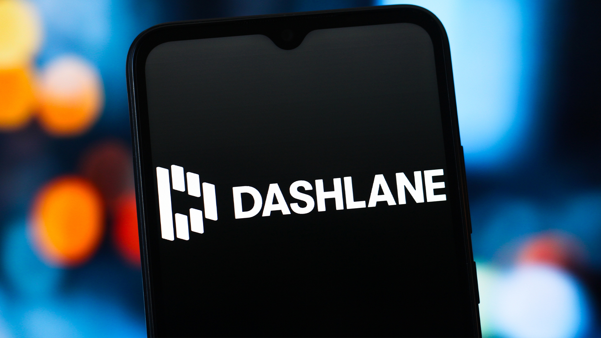 Dashlane logo and branding pictured on a smartphone screen, with logo in white lettering against a black background.