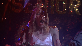 Screenshot of Carrie right after blood dropped on her in 1976's Carrie