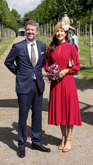 Crown Prince Frederik and Crown Princess Mary stand at the entry to the churchyard as they attend celebrations of Christiansfeld's 250th anniversary