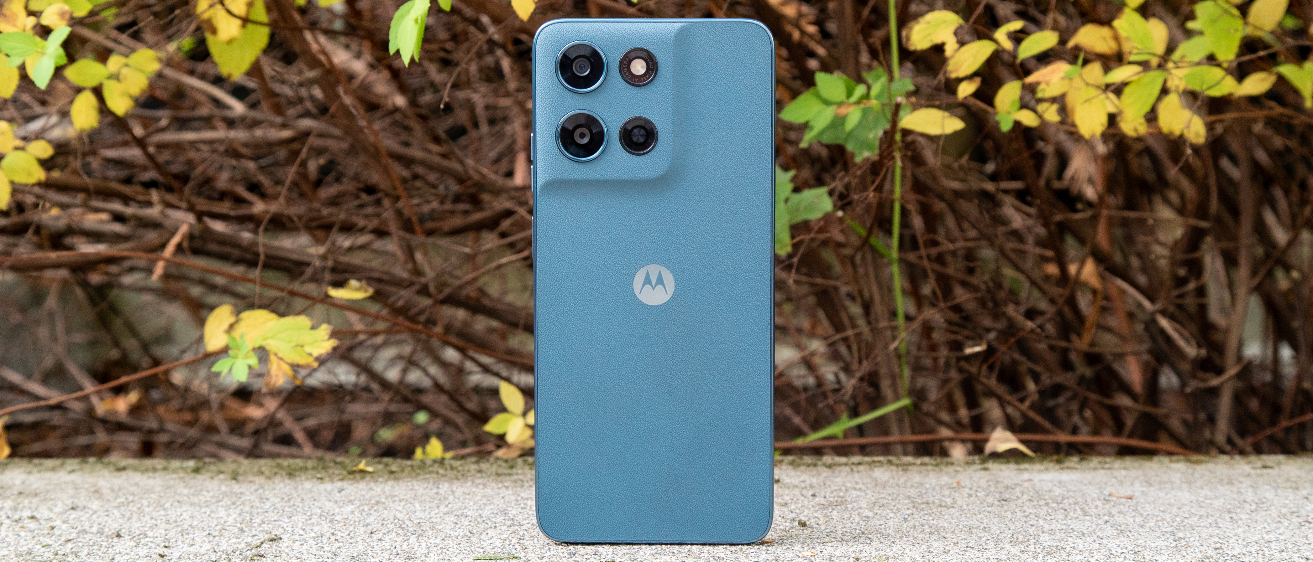 Moto G Play 2026 in front of a bush