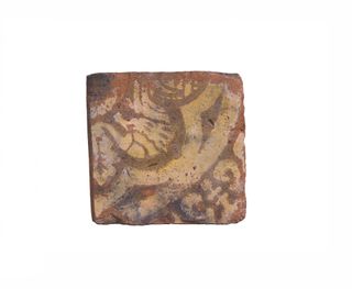 The tile depicts a mythical creature with a human head at one end and a leaf-like tail at the other.