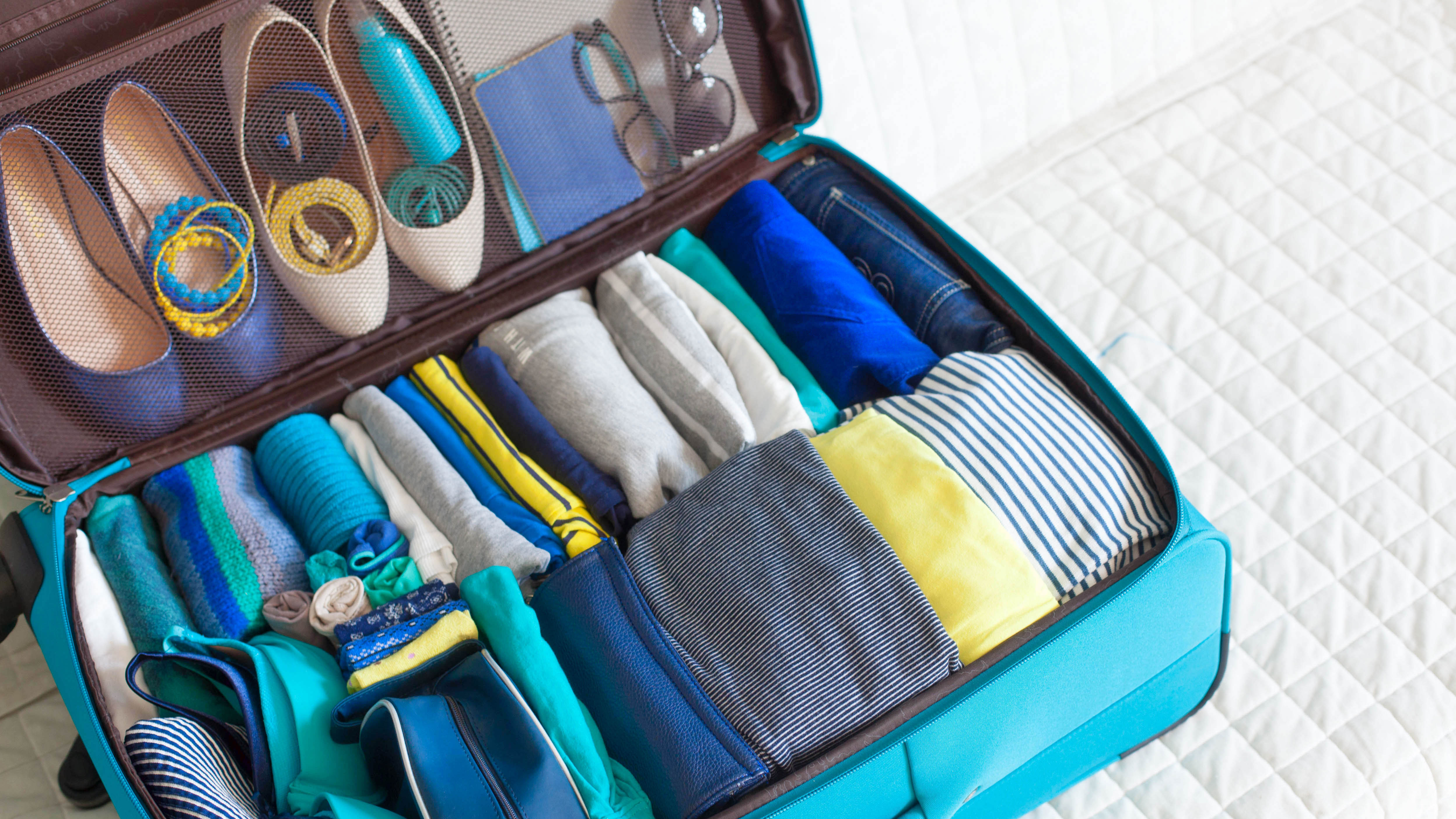 Packed suitcase with small items in footwear