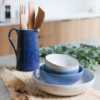 room with blue spoon holder wooden spatula and white bowl