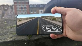 The Xiaomi Mi 11 with an image of Route 66 on its screen