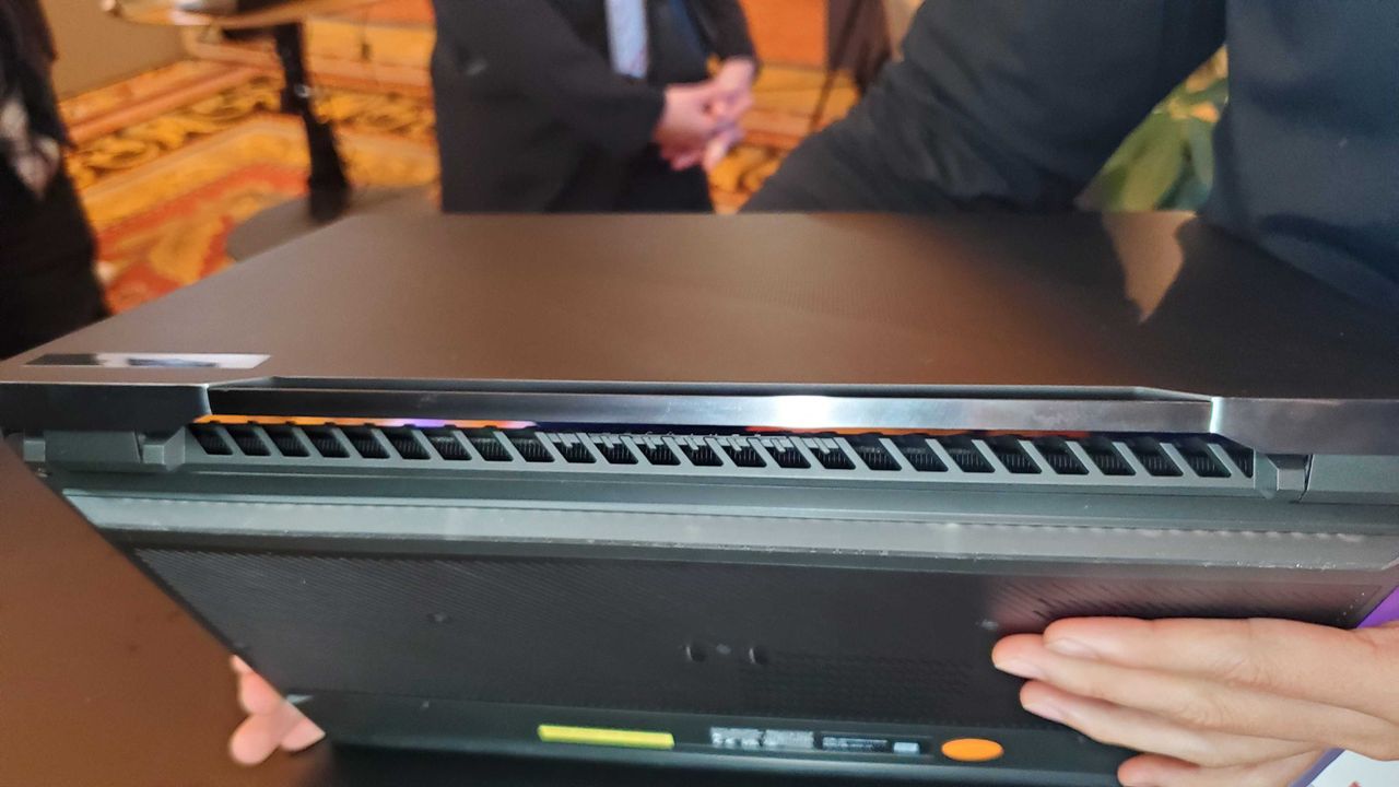 black gaming laptop with lit keyboard and vents