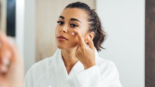 women rubbing cream into her face for the ultimate pampering routine
