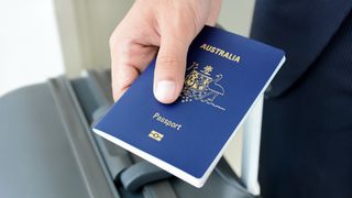 Hand holding Australian passport