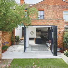 Exterior shot of rear single storey brick extension with corner bifold doors