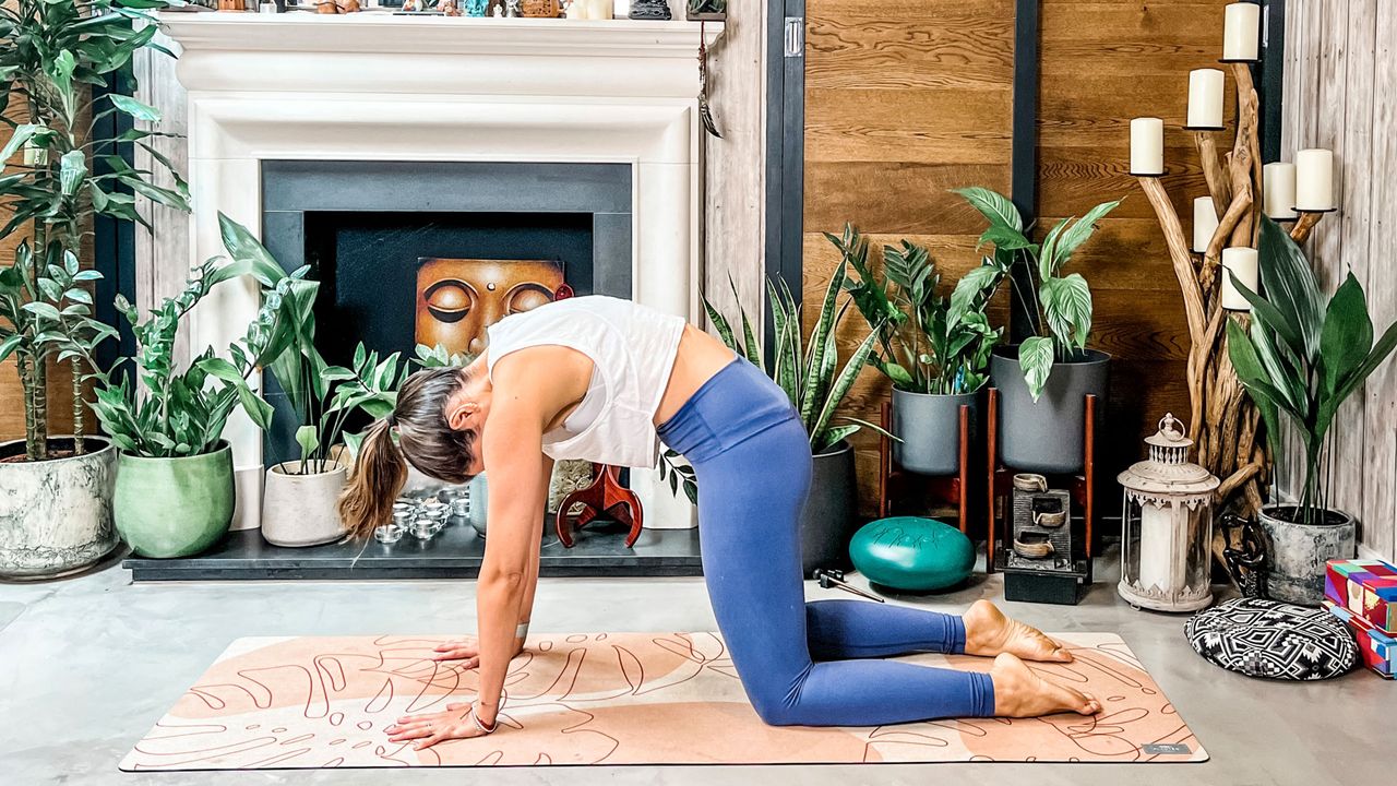 Woman doing Cat-Cow yoga pose.