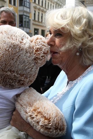 Queen Camilla cuddling with a teddy bear