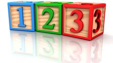 Three wooden blocks bearing the numerals 1, 2 and 3 are lined up. 