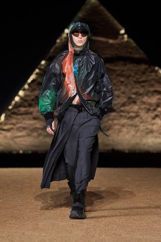 Model in jacket with star print on Dior menswear runway in Egypt