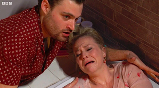 Sharon squirts Linda with water in the bath with Johnny