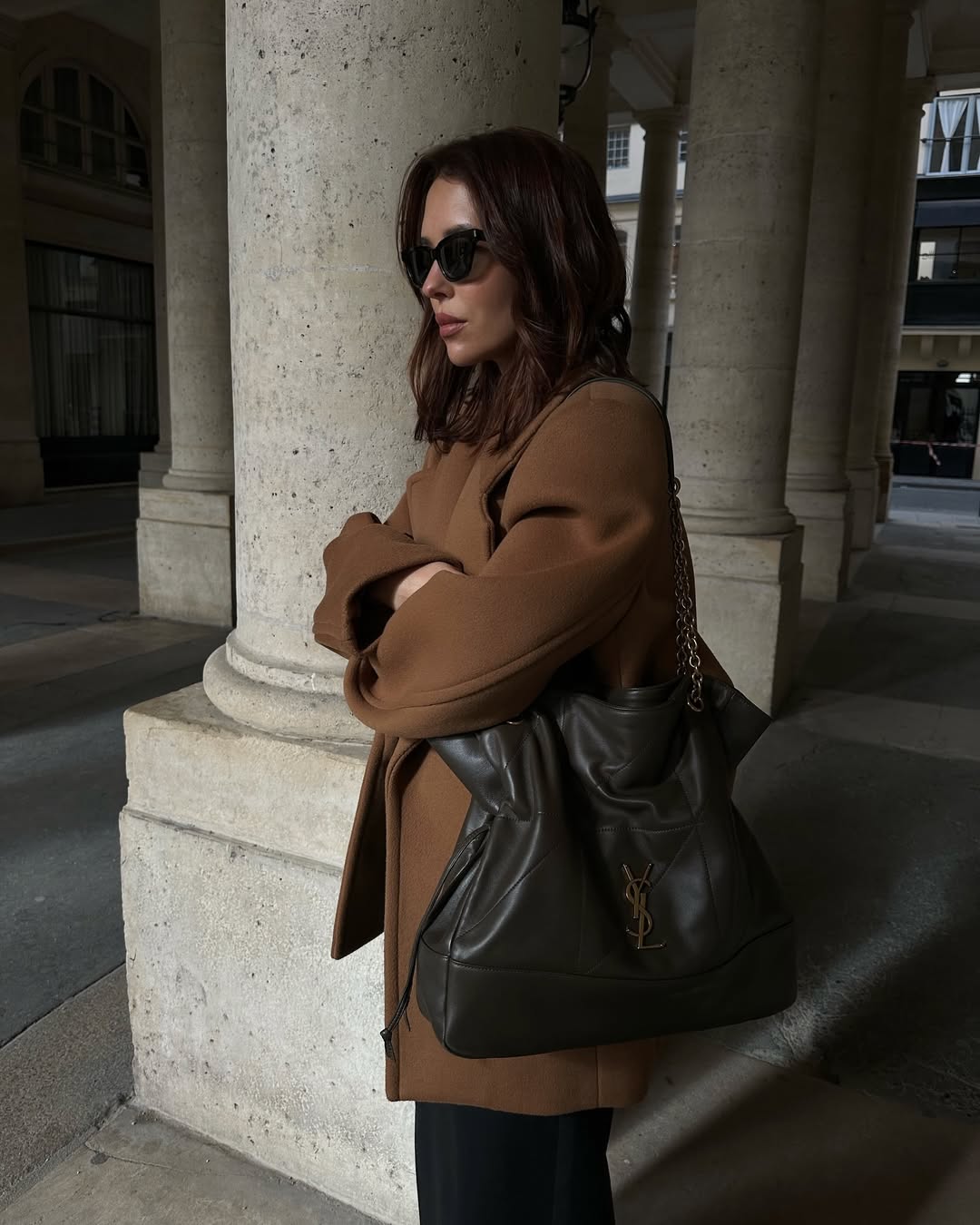 Woman wears brown blazer, saint laurent jamie shopping bag, black trousers