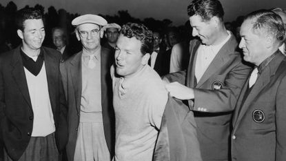Jack Burke Jr. (centre) receives his green jacket at the 1956 Masters.
