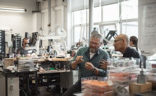 Production manager Lars Grejsmark quality checking precious frames with team member Ha Hong Nguyen