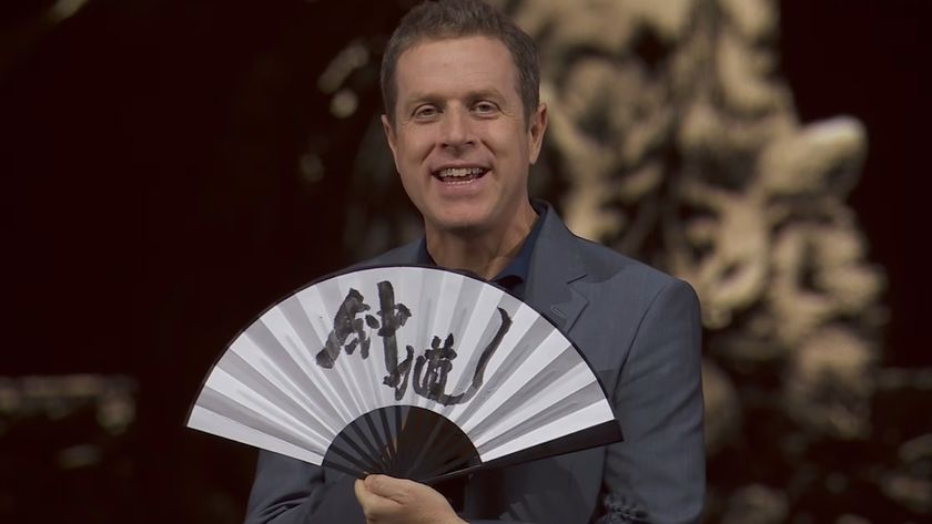Geoff Keighley celebrating the reveal of Black Myth: Zhong Kui with an unfolded fan at Gamescom Opening Night Live 2025.