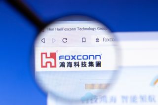 The Foxconn logo on a website under a magnifying glass