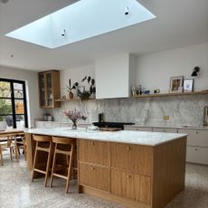 Jenny McFarlane's white kitchen painted in Farrow & Ball's All White with a marble worktop and backsplash