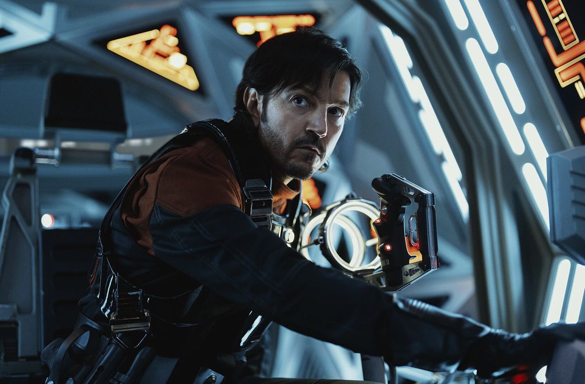 An intense man suited up inside a spaceship