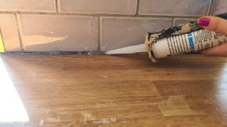 Applying silicone to a tiled wall