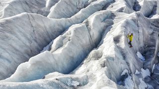 A climber scaling a wall of ice on the Aletsch glacier in Switzerland.