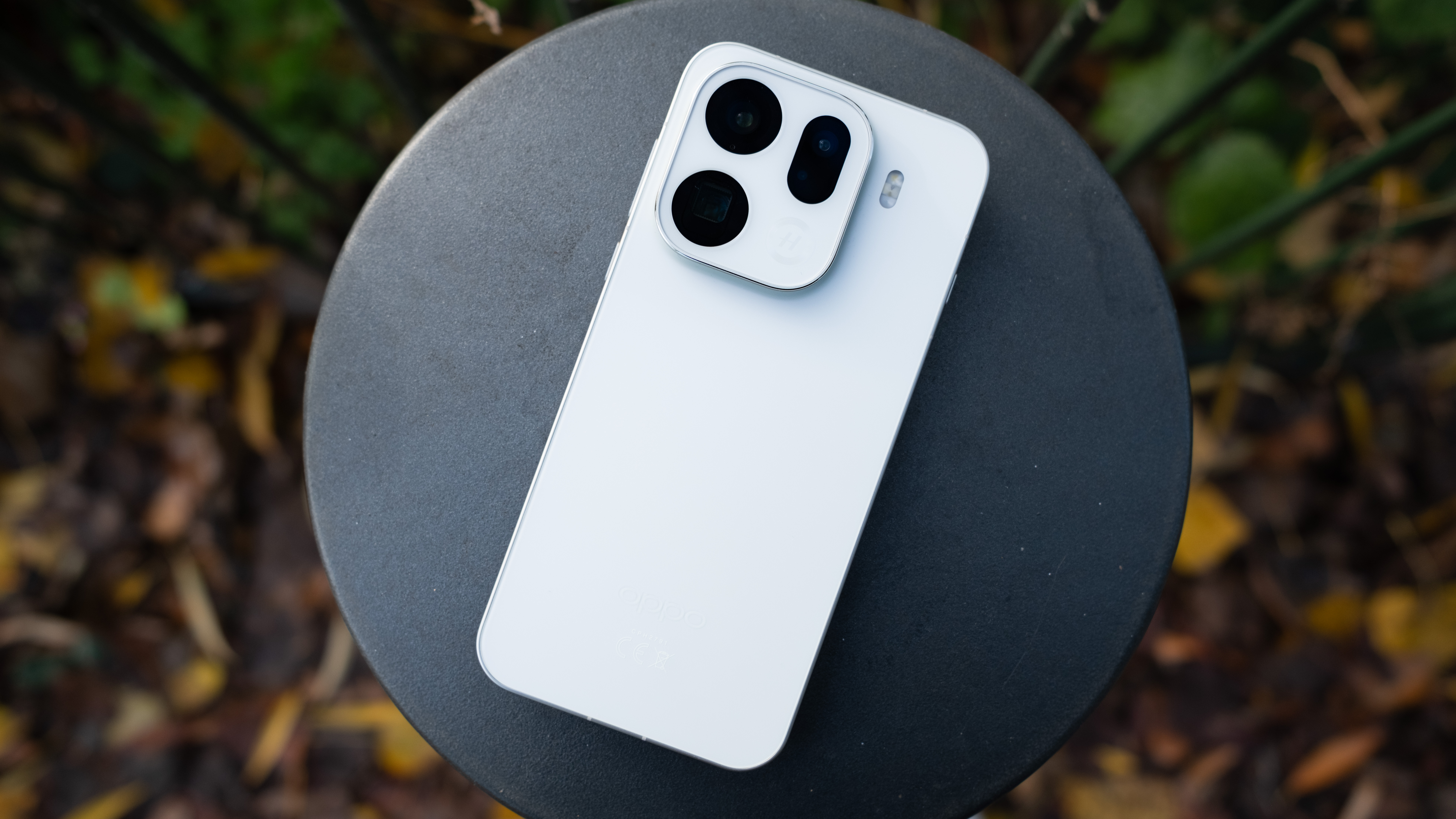 Oppo Find X8 Pro phone on a black post