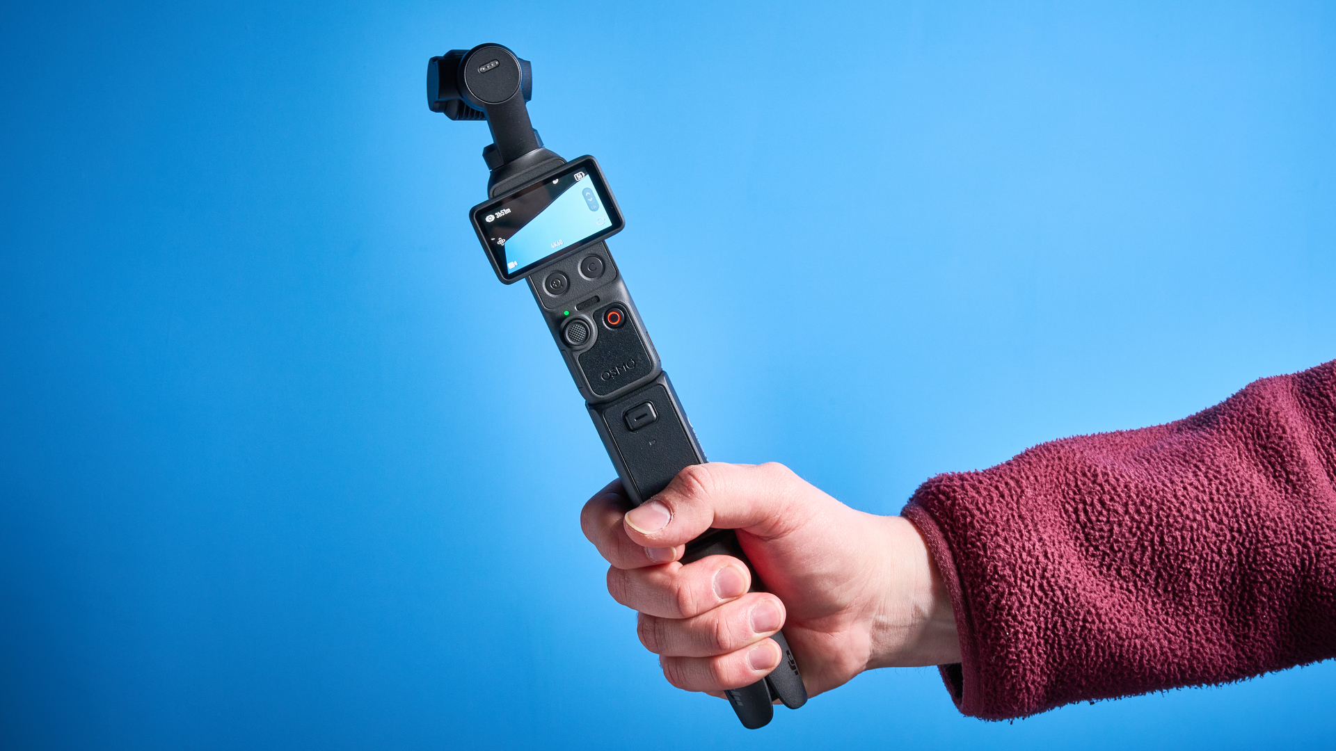 DJI Osmo Pocket 4 against a blue background