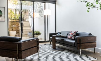 brown and black leather armchair and sofa, from Case Furniture Forum collection by Robin Day