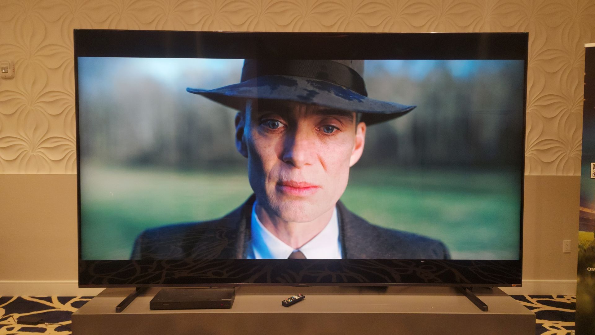 Hisense 116UX showing image of Oppenheimer onscreen